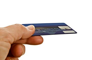 Hand offering credit or debit card