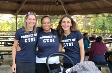 Three women with a baby stroller at a CTSI scholar reunion