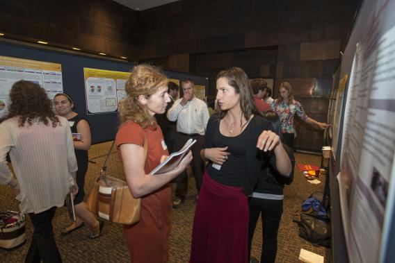 Bachanova connects with a fellow University researcher at CTSI's annual Poster Session & Reception