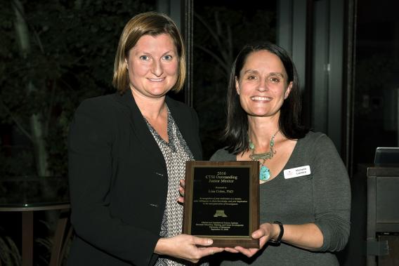 Dr. Lisa Coles and Award Plaque