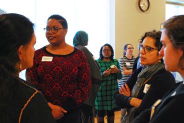 Grantees and attendees discuss community-engaged research during the Poster Session