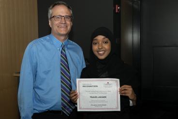 Hani Abi holding award certificate