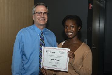 Anita Kwashie holding award certificate