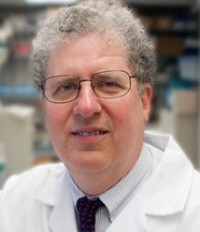 Dr. Bruce Balazar headshot in a lab coat
